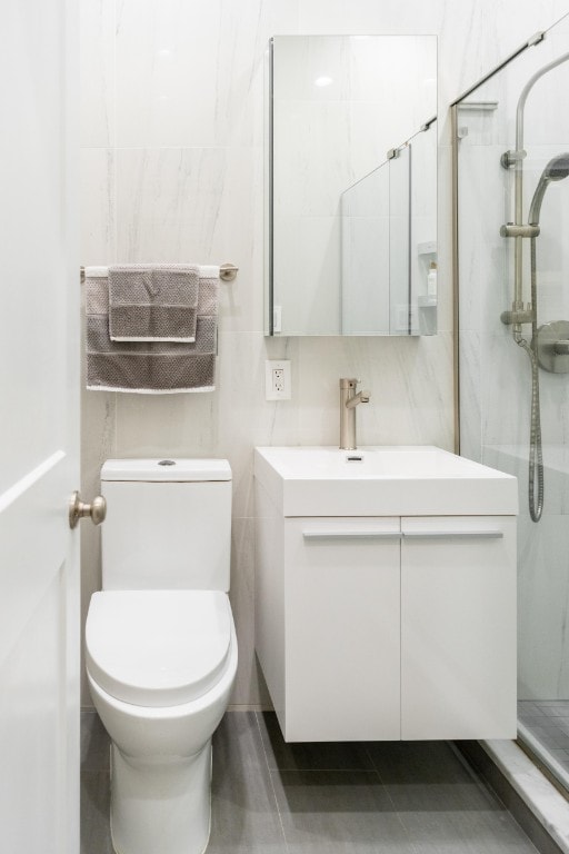 344 E 58th St Unit A, New York City, NY 10022 - full bathroom featuring vanity, a walk in shower, and tile walls