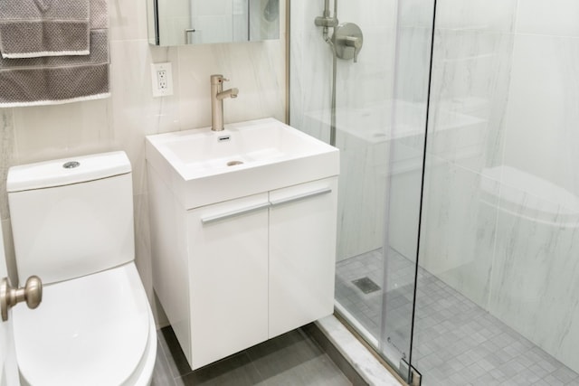 344 E 58th St Unit A, New York City, NY 10022 - bathroom featuring vanity, a shower stall, and tile walls