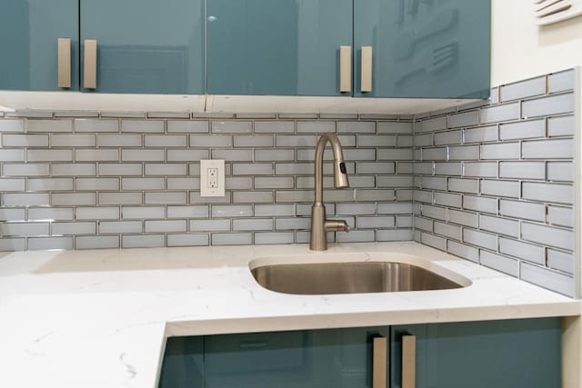 344 E 58th St Unit A, New York City, NY 10022 - kitchen view of tasteful backsplash, blue cabinets, and light stone counters