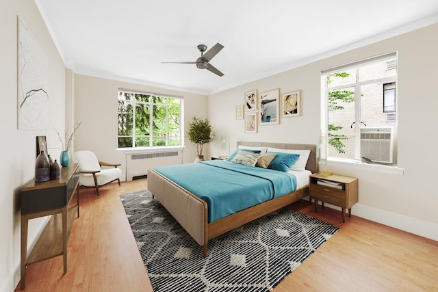 250 W 24th St Unit 1Cw, New York City, NY 10011 - bedroom with radiator, ornamental molding, wood finished floors, and multiple windows