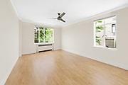 250 W 24th St Unit 1Cw, New York City, NY 10011 - unfurnished living room featuring ceiling fan, wood finished floors, and crown molding
