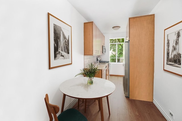250 W 24th St Unit 1Cw, New York City, NY 10011 - dining room featuring wood finished floors and baseboards