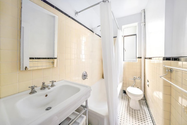 250 W 24th St Unit 1Cw, New York City, NY 10011 - full bath with tile walls, shower / bath combo with shower curtain, and tile patterned floors