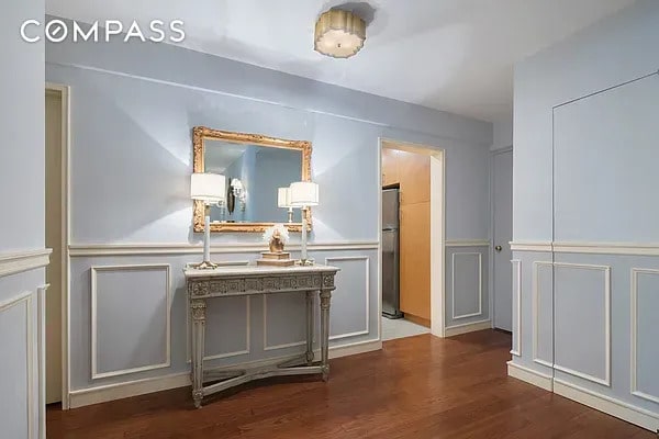 30 E 9th St Unit 2Ii, New York City, NY 10003 - hallway with a decorative wall, wood finished floors, and a wainscoted wall
