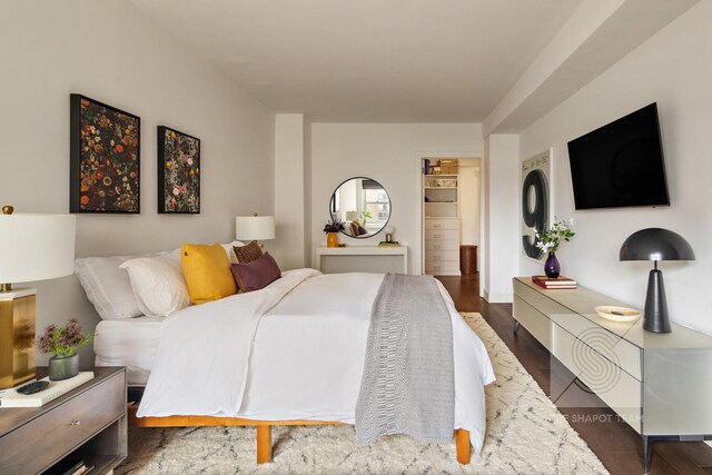 165 W 66th St Unit 21Ef, New York City, NY 10023 - bedroom featuring a walk in closet and dark wood-style flooring
