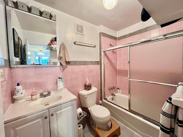 298 12th St Unit 2F, New York City, NY 11215 - bathroom with vanity, bath / shower combo with glass door, tile patterned floors, and tile walls