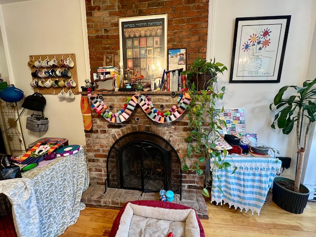 298 12th St Unit 2F, New York City, NY 11215 - living room with wood finished floors and a brick fireplace