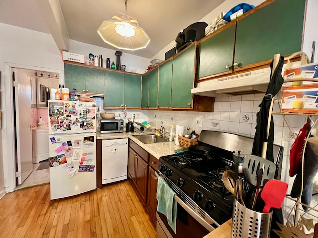 298 12th St Unit 2F, New York City, NY 11215 - kitchen featuring stainless steel appliances, under cabinet range hood, light wood-type flooring, light countertops, and backsplash
