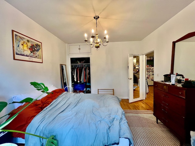 298 12th St Unit 2F, New York City, NY 11215 - bedroom featuring a chandelier, a closet, and light wood-style flooring