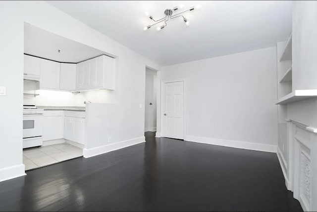 367 Carlton Ave, New York City, NY 11238 - unfurnished living room featuring baseboards and wood finished floors