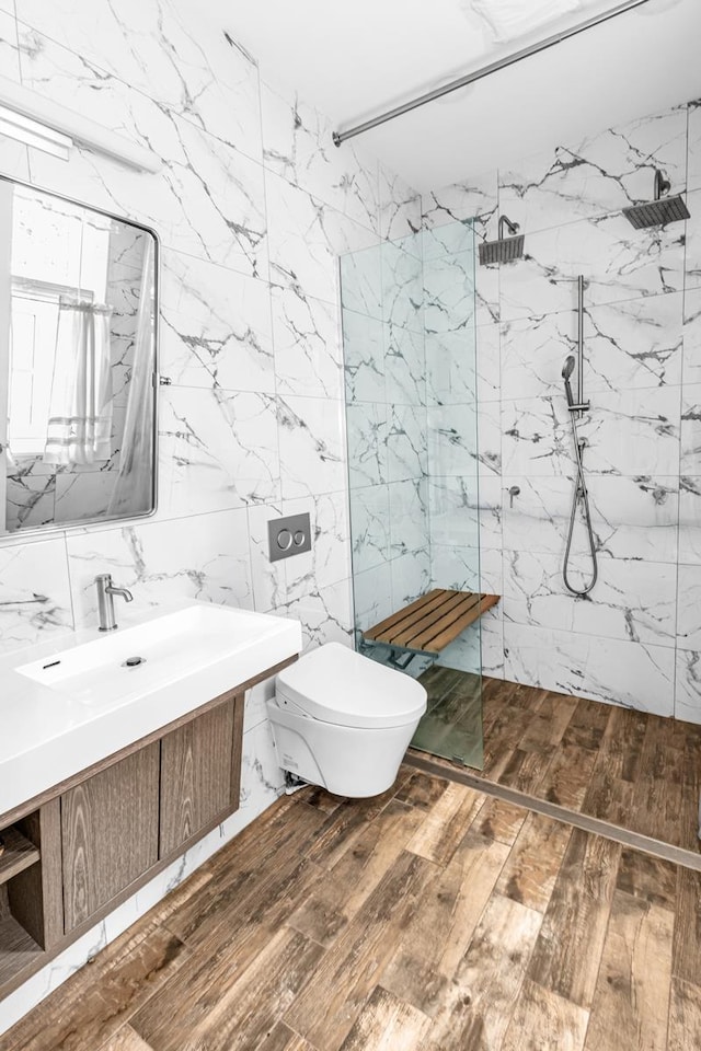 367 Carlton Ave, New York City, NY 11238 - bathroom featuring wood-type flooring, vanity, tile walls, and a marble finish shower