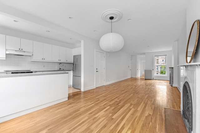 367 Carlton Ave, New York City, NY 11238 - unfurnished living room with light wood-style floors and radiator heating unit