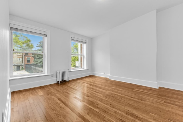 367 Carlton Ave, New York City, NY 11238 - unfurnished room featuring radiator and light wood-style flooring