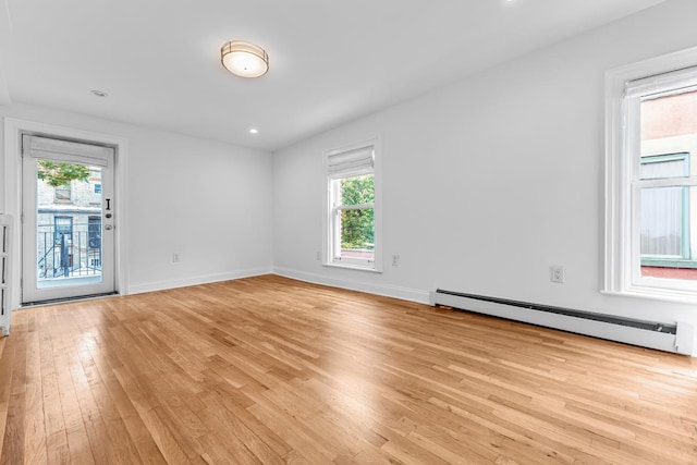 367 Carlton Ave, New York City, NY 11238 - unfurnished room with a baseboard heating unit, light wood finished floors, and recessed lighting
