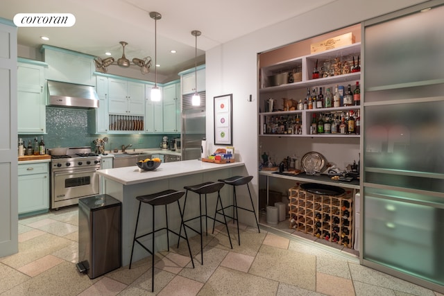 17 Murray St Unit 4Fl, New York City, NY 10007 - kitchen featuring premium appliances, dark aggregate flooring, range hood, a peninsula, and recessed lighting