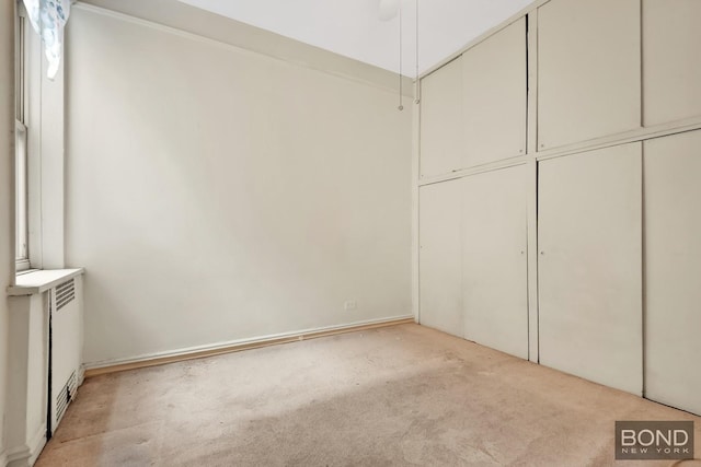 3321 Bruckner Blvd Unit 2D, New York City, NY 10461 - unfurnished bedroom featuring light carpet and radiator heating unit