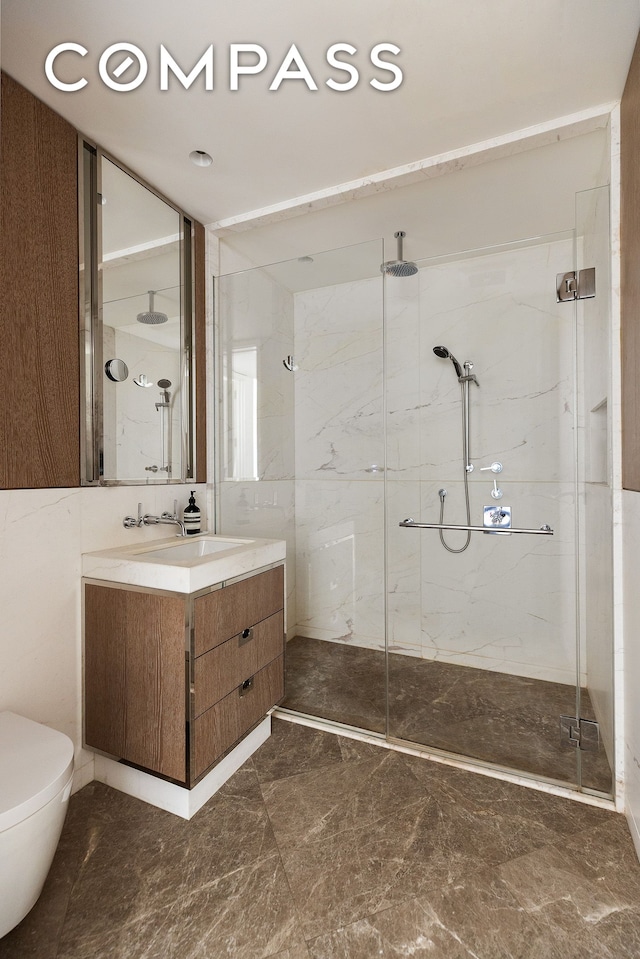 40 Bleecker St Unit 3E, New York City, NY 10012 - bathroom with a marble finish shower, vanity, marble finish floors, and toilet
