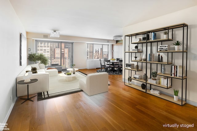 400 E 56th St Unit 27H, New York City, NY 10022 - living room featuring wood finished floors and baseboards