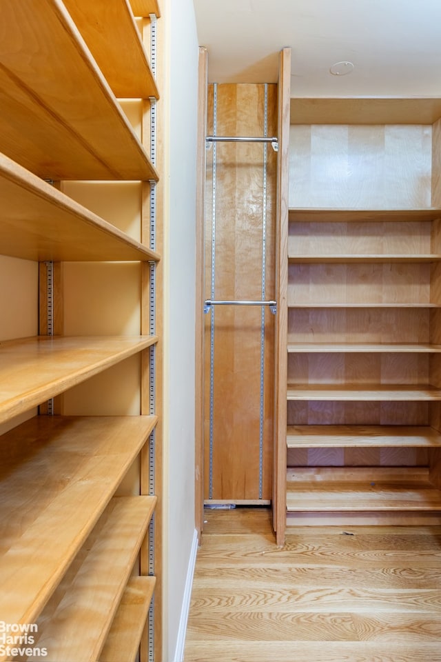 400 E 56th St Unit 27H, New York City, NY 10022 - walk in closet featuring wood finished floors