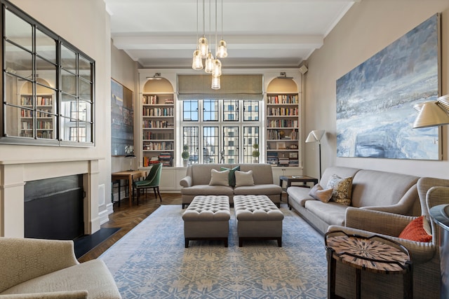 14 E 75th St Unit 10D, New York City, NY 10021 - living room with a fireplace with flush hearth, ornamental molding, built in shelves, parquet flooring, and a chandelier