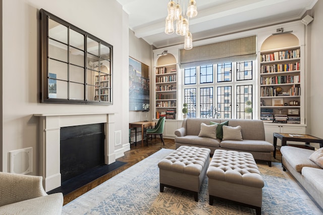 14 E 75th St Unit 10D, New York City, NY 10021 - living room featuring built in shelves, ornamental molding, a fireplace with flush hearth, a chandelier, and parquet floors
