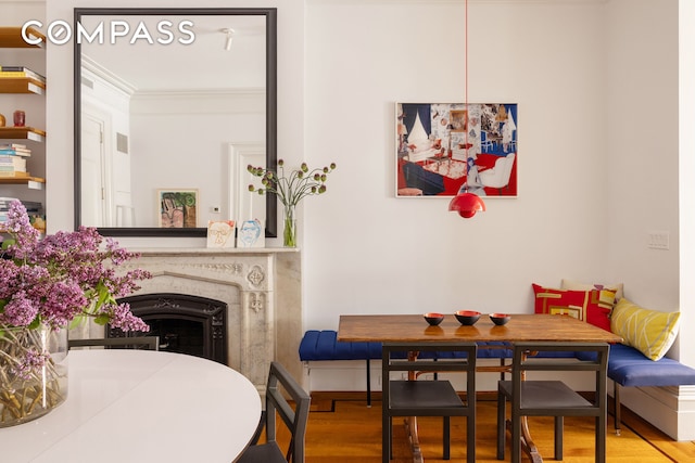 9 W 16th St Unit 3, New York City, NY 10011 - dining space featuring wood finished floors, ornamental molding, and a fireplace