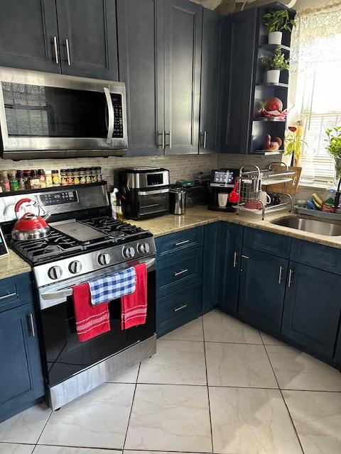 1181 Bushwick Ave, New York City, NY 11221 - kitchen with appliances with stainless steel finishes, decorative backsplash, a sink, light marble finish floors, and open shelves