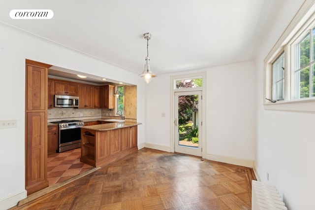 72-23 Kessel St, New York City, NY 11375 - kitchen featuring appliances with stainless steel finishes, radiator heating unit, open shelves, brown cabinetry, and decorative backsplash