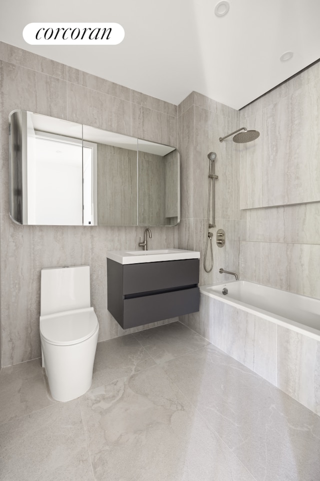 1118 Fulton St Unit 5F, New York City, NY 11238 - full bathroom with tiled shower / bath combo, tile walls, and vanity