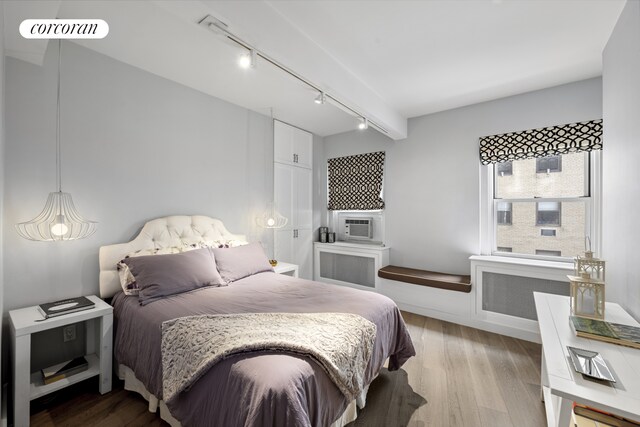 2166 Broadway Unit 7B, New York City, NY 10024 - bedroom featuring rail lighting, light wood-type flooring, radiator, and cooling unit