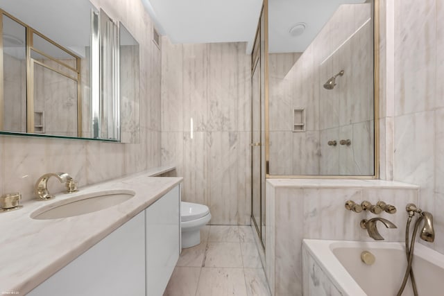 530 E 76th St Unit 18G, New York City, NY 10021 - full bathroom with tile walls, vanity, a bath, a shower stall, and toilet