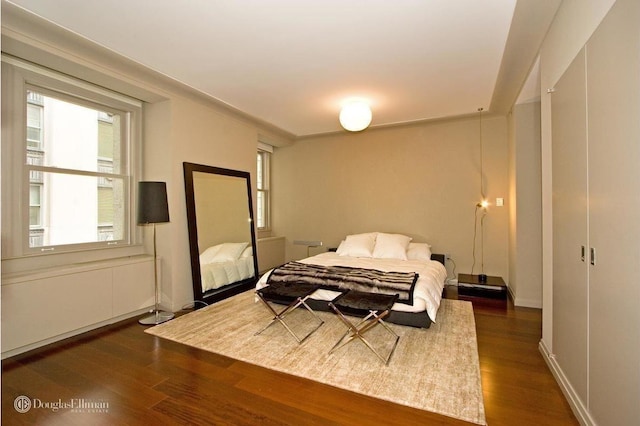 55 Wall St Unit 816, New York City, NY 10005 - bedroom featuring dark wood-style flooring and baseboards