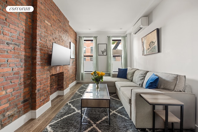 66 Steuben St Unit 1R, New York City, NY 11205 - living area with a wall mounted AC, brick wall, baseboards, and wood finished floors
