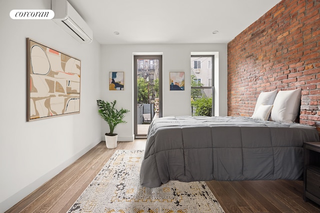 66 Steuben St Unit 1R, New York City, NY 11205 - bedroom with access to exterior, an AC wall unit, light wood-style floors, and brick wall