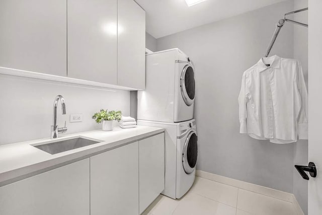 21 W 20th St Unit Ph1, New York City, NY 10011 - laundry room featuring stacked washing machine and dryer, cabinet space, and light tile patterned flooring