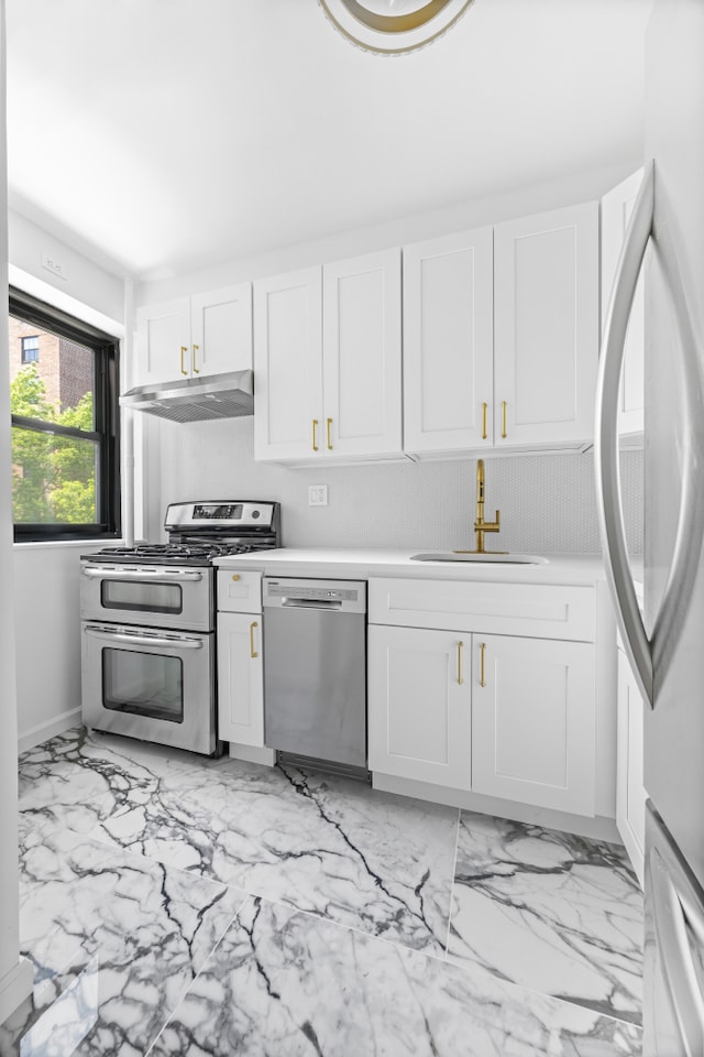 365 Clinton Ave Unit 6F, New York City, NY 11238 - kitchen featuring appliances with stainless steel finishes, under cabinet range hood, white cabinetry, light countertops, and light marble finish flooring