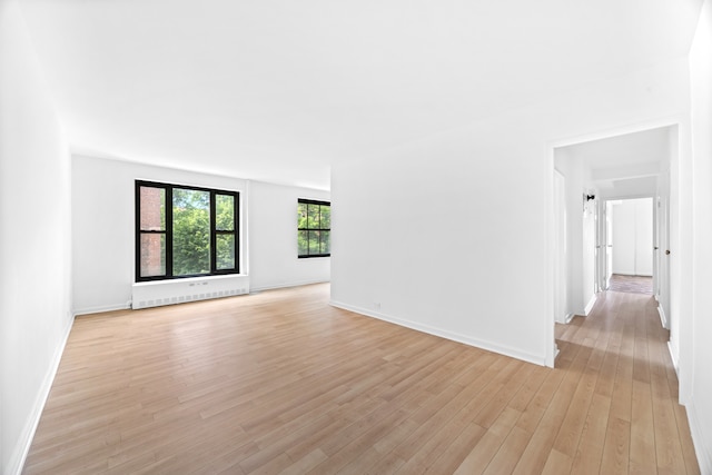 365 Clinton Ave Unit 6F, New York City, NY 11238 - spare room with light wood-style floors and radiator heating unit