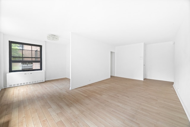 365 Clinton Ave Unit 6F, New York City, NY 11238 - unfurnished room with radiator, light wood finished floors, and cooling unit