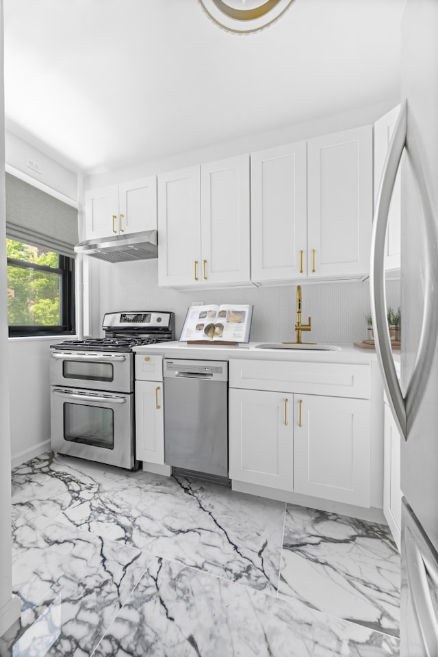 365 Clinton Ave Unit 6F, New York City, NY 11238 - kitchen featuring appliances with stainless steel finishes, under cabinet range hood, white cabinetry, and light marble finish flooring