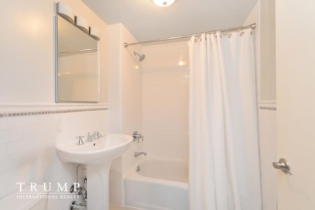 303 W 146th St Unit 7-R, New York City, NY 10039 - bathroom featuring shower / tub combo with curtain and tile walls