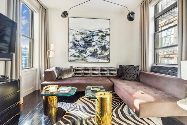 105 E 15th St Unit 106, New York City, NY 10003 - living area with plenty of natural light, wood finished floors, cooling unit, and baseboards