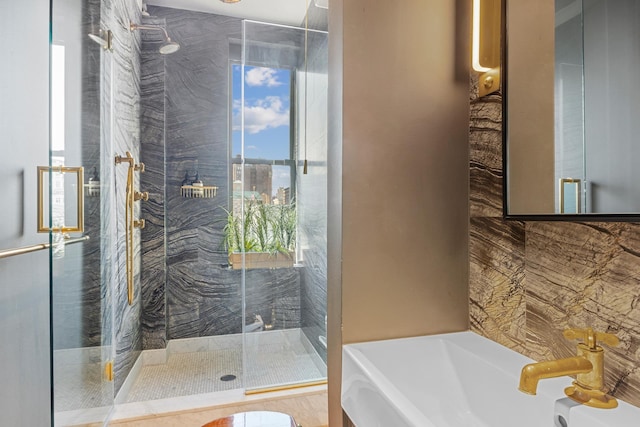 105 E 15th St Unit 106, New York City, NY 10003 - bathroom with healthy amount of natural light, a stall shower, a garden tub, and a sink