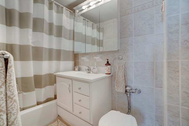 229 E 29th St Unit E-3, New York City, NY 10016 - full bathroom with tile walls, vanity, shower / bath combo, and toilet