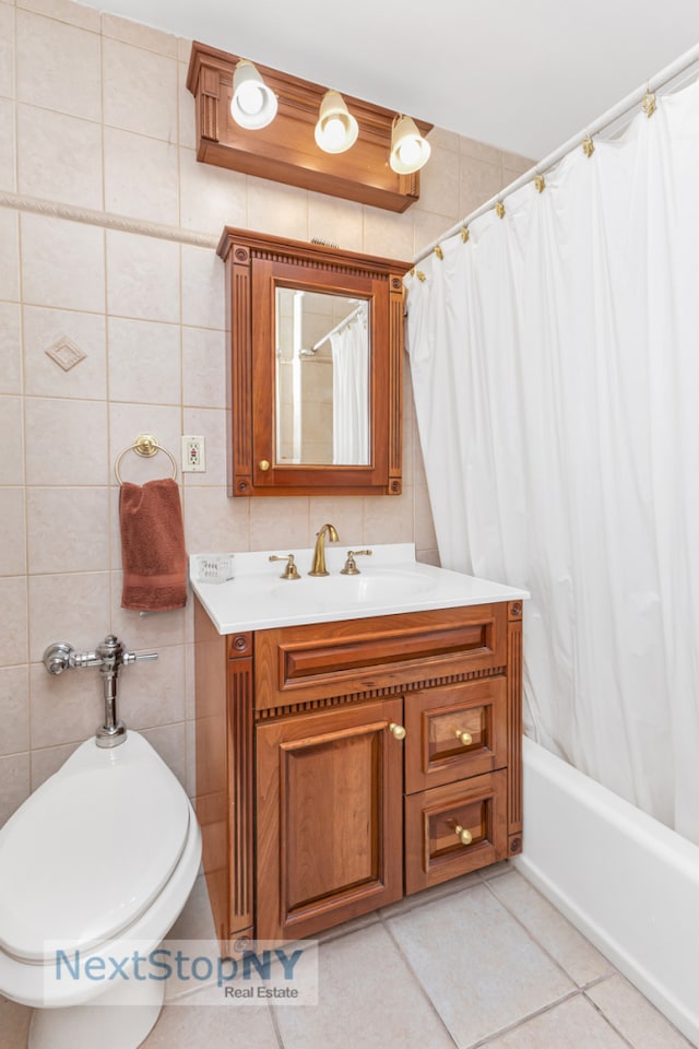 411 E 57th St Unit 2E, New York City, NY 10022 - bathroom featuring vanity, tile walls, shower / bath combo with shower curtain, and tile patterned floors