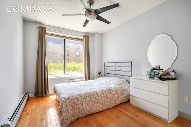 29 W 138th St Unit 5A, New York City, NY 10037 - bedroom featuring baseboard heating, light wood finished floors, a ceiling fan, and baseboards