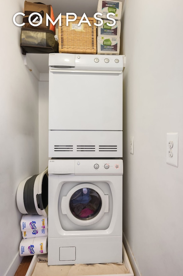 29 W 138th St Unit 5A, New York City, NY 10037 - laundry room with stacked washer / dryer and baseboards