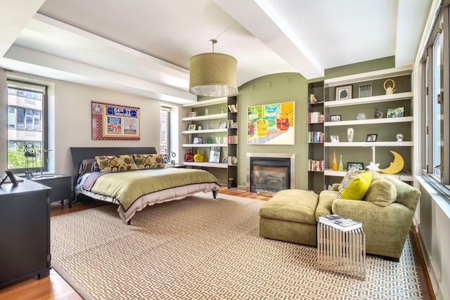 43 W 64th St Unit 6A, New York City, NY 10023 - bedroom featuring wood finished floors and a glass covered fireplace