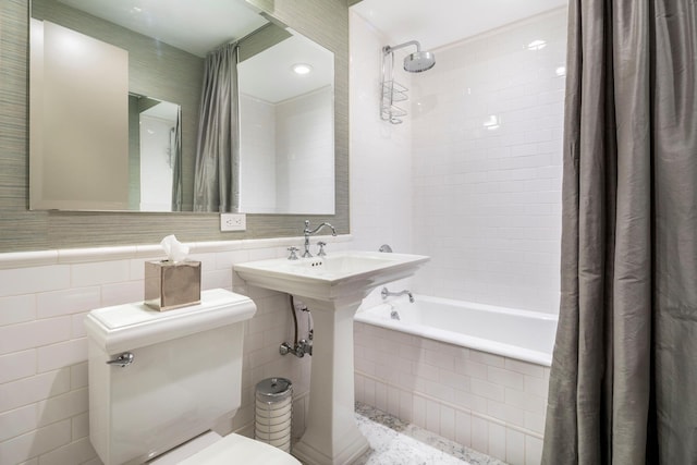 43 W 64th St Unit 6A, New York City, NY 10023 - bathroom with toilet, tile walls, tiled shower / bath, and wainscoting