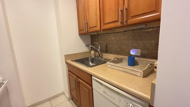 311 E 38th St Unit 12C, New York City, NY 10016 - kitchen with white dishwasher, tasteful backsplash, a sink, light tile patterned floors, and light countertops