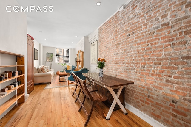 334 E 5th St Unit 2, New York City, NY 10003 - dining space featuring brick wall and light wood finished floors